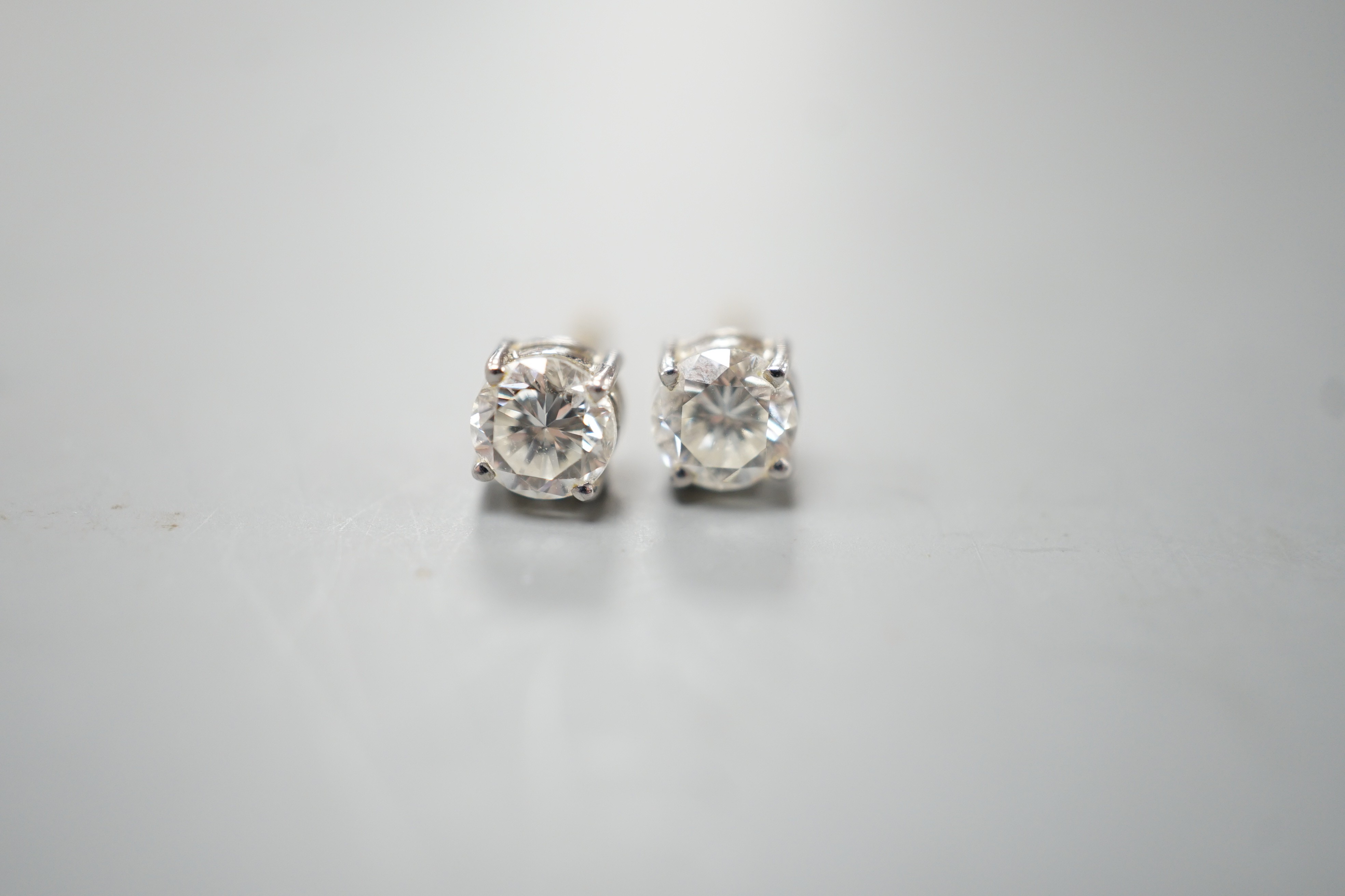 A pair of 18ct gold and solitaire diamond set ear studs, stone diameter approx. 4.8mm, gross weight 1.2 grams.